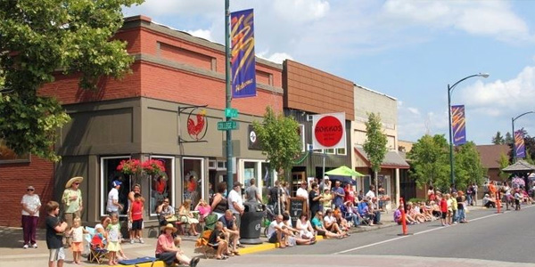 Cheney Web Design and Marketing: Street view of Rokkos Japanese restaurant during a lively parade showcasing local businesses.