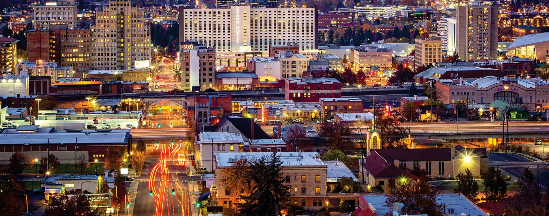 Spokane Web Design and Marketing reflecting the vibrant nighttime skyline of downtown Spokane.
